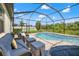 Screened pool area with luxury outdoor seating, a privacy fence and landscaping at 11434 Leland Groves Dr, Riverview, FL 33579