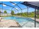 Screened-in pool with a spa feature, surrounded by pavers and lush landscaping at 11434 Leland Groves Dr, Riverview, FL 33579