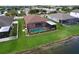 An aerial view of the home's screened lanai with a kidney shaped pool overlooking the water at 11614 Ashton Field Ave, Riverview, FL 33579