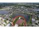 Aerial view of the community showing houses, lakes, community pool, and proximity to nearby neighborhoods at 11614 Ashton Field Ave, Riverview, FL 33579
