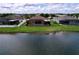 Aerial view of a home with a screened pool, backyard, and waterfront view of the lake at 11614 Ashton Field Ave, Riverview, FL 33579