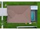 Bird's-eye view of the home's roof and pool with screened-in lanai with landscaping and green lawn at 11614 Ashton Field Ave, Riverview, FL 33579