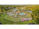 Aerial view of community pool, playground, and surrounding green spaces at 11614 Ashton Field Ave, Riverview, FL 33579