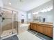 Bathroom with a walk-in shower, soaking tub, double sink vanity, granite countertops and tile flooring at 11614 Ashton Field Ave, Riverview, FL 33579