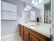 Bathroom featuring a double sink vanity with a large mirror and contemporary lighting at 11614 Ashton Field Ave, Riverview, FL 33579