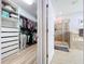 Bathroom featuring a bathtub, separate glass shower, and door to a walk in closet with built in shelves at 11614 Ashton Field Ave, Riverview, FL 33579