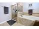 Bathroom showcasing a glass-enclosed shower and a soaking tub, complemented by tile flooring and neutral wall colors at 11614 Ashton Field Ave, Riverview, FL 33579