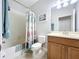 Bathroom with a shower/tub combo featuring a coastal-themed shower curtain, vanity, and toilet at 11614 Ashton Field Ave, Riverview, FL 33579