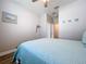 Bright bedroom featuring a ceiling fan, beach-themed décor, and a comfortable blue quilted bedspread at 11614 Ashton Field Ave, Riverview, FL 33579