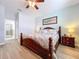 Charming main bedroom featuring wood floors, beach-themed decor, and an attached bathroom for added convenience at 11614 Ashton Field Ave, Riverview, FL 33579
