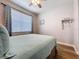 Cozy bedroom featuring a large window with natural light and a comfortable bed at 11614 Ashton Field Ave, Riverview, FL 33579