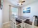 Casual dining room with window view and unique modern art at 11614 Ashton Field Ave, Riverview, FL 33579