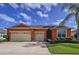 Charming single-story home with a three-car garage, well-maintained landscaping, and an orange painted stucco facade at 11614 Ashton Field Ave, Riverview, FL 33579