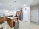 A modern kitchen featuring granite countertops, an island, and stainless steel appliances at 11614 Ashton Field Ave, Riverview, FL 33579
