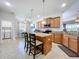 A modern kitchen featuring granite countertops, an island, and stainless steel appliances at 11614 Ashton Field Ave, Riverview, FL 33579