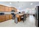 Open concept kitchen featuring an island, breakfast bar, and stainless steel appliances at 11614 Ashton Field Ave, Riverview, FL 33579