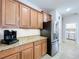 Bright kitchen features granite counters, stainless steel refrigerator, and light wood cabinetry at 11614 Ashton Field Ave, Riverview, FL 33579
