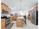 Modern kitchen features an island, stainless steel appliances, and adjacent living space at 11614 Ashton Field Ave, Riverview, FL 33579