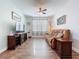 Comfortable living room with stylish decor, wood floors, and a large window offering ample natural light at 11614 Ashton Field Ave, Riverview, FL 33579