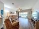 Spacious living room with ceiling fan and sliding doors overlooking the pool and water at 11614 Ashton Field Ave, Riverview, FL 33579