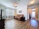 Cozy living room features wood floors, neutral walls, and comfortable seating, creating a relaxing ambiance at 11614 Ashton Field Ave, Riverview, FL 33579