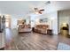 Bright living room featuring an open layout, wood floors, and neutral decor, creating a welcoming atmosphere at 11614 Ashton Field Ave, Riverview, FL 33579