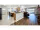 Open concept living space with kitchen, dinette, and living room overlooking water at 11614 Ashton Field Ave, Riverview, FL 33579