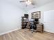 Office with hard wood floors, built-in shelving, ceiling fan, and neutral walls at 11614 Ashton Field Ave, Riverview, FL 33579