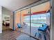 View of the screened-in patio featuring outdoor furniture and a stunning view of the pool and lake at 11614 Ashton Field Ave, Riverview, FL 33579