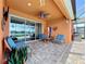 Inviting screened patio with stylish furniture, ceiling fan, and scenic views of the pool and lake at 11614 Ashton Field Ave, Riverview, FL 33579