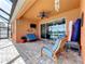 Relaxing screened patio featuring cozy seating, ceiling fan, and sliding glass doors to the house at 11614 Ashton Field Ave, Riverview, FL 33579