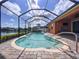 Relaxing screened-in pool with access handrail overlooking a serene waterfront view at 11614 Ashton Field Ave, Riverview, FL 33579