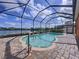 Screened-in pool overlooking the lake, with brick pavers and a handrail for easy access at 11614 Ashton Field Ave, Riverview, FL 33579