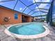 A kidney-shaped pool with an attached spa and a screened enclosure for privacy at 11614 Ashton Field Ave, Riverview, FL 33579