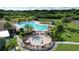 Community pool with a separate hot tub and a nearby playground area at 11614 Ashton Field Ave, Riverview, FL 33579
