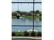 Waterfront backyard view of a home with a screened in pool, and a group of pelicans at the water's edge at 11614 Ashton Field Ave, Riverview, FL 33579