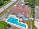 Aerial view of a private backyard featuring an in-ground pool, patio area and hot tub at 12546 108Th St, Largo, FL 33778