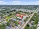 Aerial shot shows the neighborhood, nearby community buildings, and manicured lawns at 12546 108Th St, Largo, FL 33778