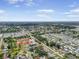 Expansive aerial view of the neighborhood showcasing its layout, homes, and proximity to the surrounding landscape and distant skyline at 12546 108Th St, Largo, FL 33778
