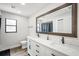 Bathroom featuring a double vanity, modern fixtures, and a large mirror at 12546 108Th St, Largo, FL 33778