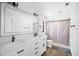 Modern bathroom with double sink vanity, large mirror and shower with light colored curtain at 12546 108Th St, Largo, FL 33778