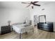 Bright bedroom featuring wood floors, ceiling fan, and a view into the ensuite bathroom at 12546 108Th St, Largo, FL 33778