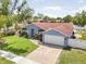 Well maintained single story home with mature landscaping, a 2-car garage, and a charming front yard at 12546 108Th St, Largo, FL 33778