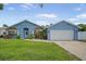 Charming single-Gathering home with a well-manicured lawn and a two-car garage on a sunny day at 12546 108Th St, Largo, FL 33778
