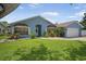 Beautiful single-story home with landscaped yard, featuring a blue exterior and well-maintained lawn at 12546 108Th St, Largo, FL 33778