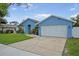 Lovely single-Gathering home boasts lush landscaping and a two-car garage for ample parking at 12546 108Th St, Largo, FL 33778