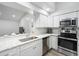 Well-lit, modern kitchen with stainless steel appliances and granite countertops with subway tile backsplash at 12546 108Th St, Largo, FL 33778