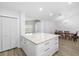Bright kitchen island with white cabinets, granite countertop, and spacious dining area at 12546 108Th St, Largo, FL 33778