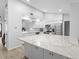Modern kitchen featuring white cabinets, granite countertops, and a large center island at 12546 108Th St, Largo, FL 33778
