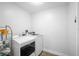 Functional laundry room with modern washer and dryer, plus convenient storage shelving at 12546 108Th St, Largo, FL 33778